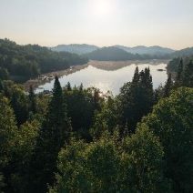Vue aérienne d'un lac au lever du soleil entre les collines boisées des Laurentides, secteur du Morgan à Saint-Adolphe-d'Howard